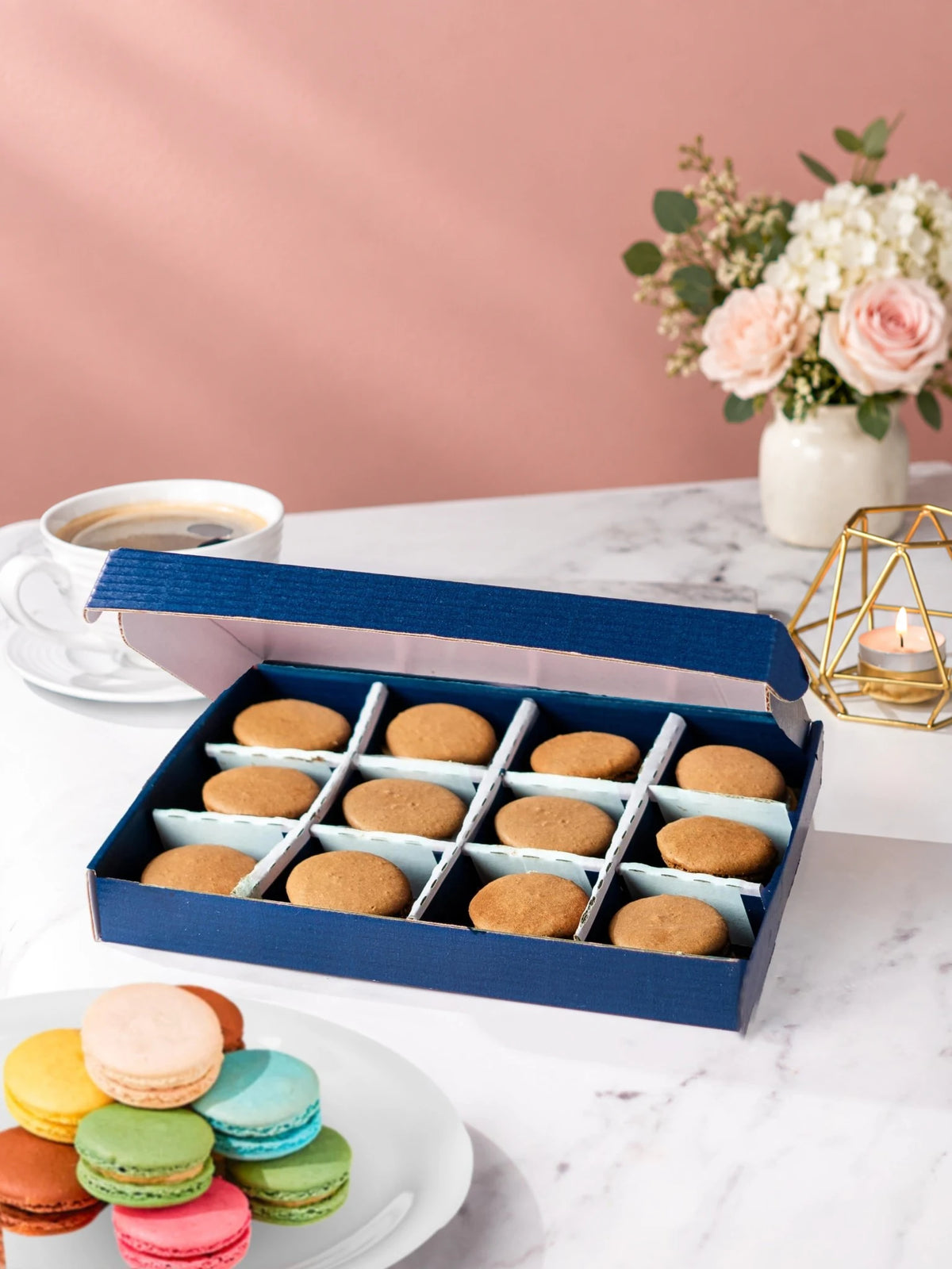 Open gift box of 12 chocolate macarons by Patisserie Valerie