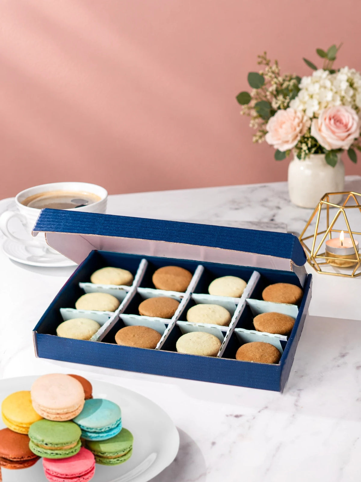 Open gift box of 12 chocolate & vanilla macarons by Patisserie Valerie