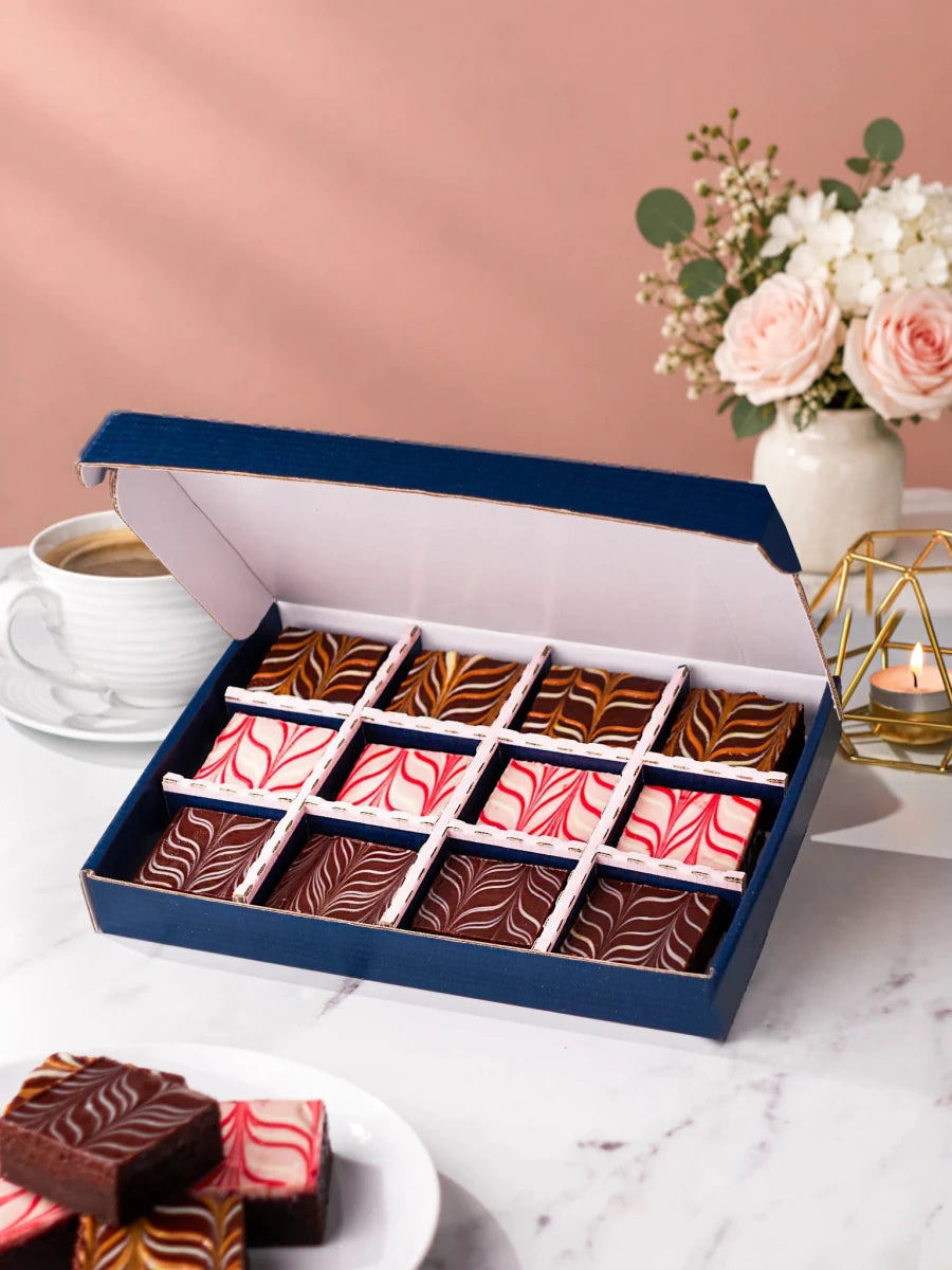 Chocolate brownies arranged in an open gift box from the Happy Birthday range by Patisserie Valerie
