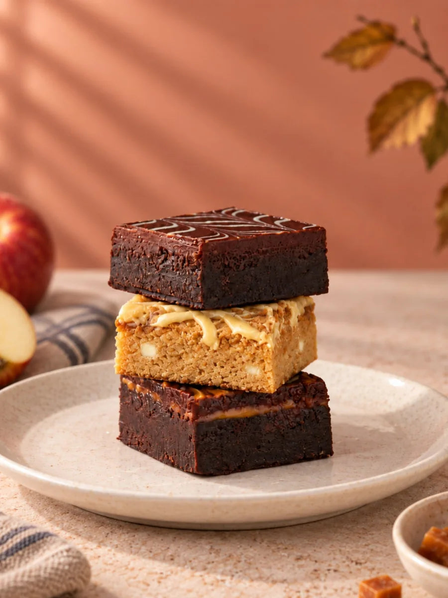Stack of a chocolate brownie, a blondie and a caramel brownie from the Indulgent Brownie & Blondie Box