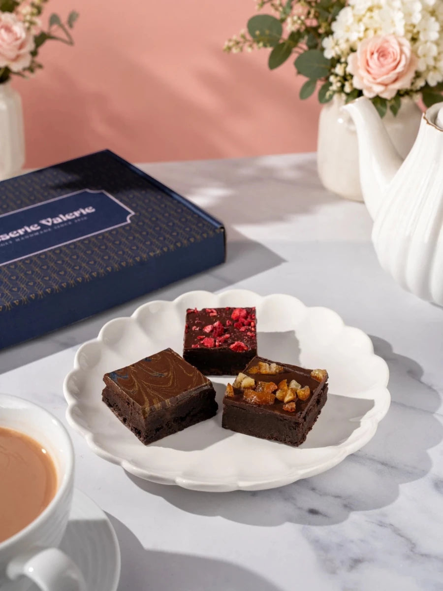 Kind Bakes vegan brownie selection on a white plate, viewed from the side by Patisserie Valerie