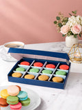 Open gift box of 12 pistachio, raspberry & salted caramel macarons by Patisserie Valerie