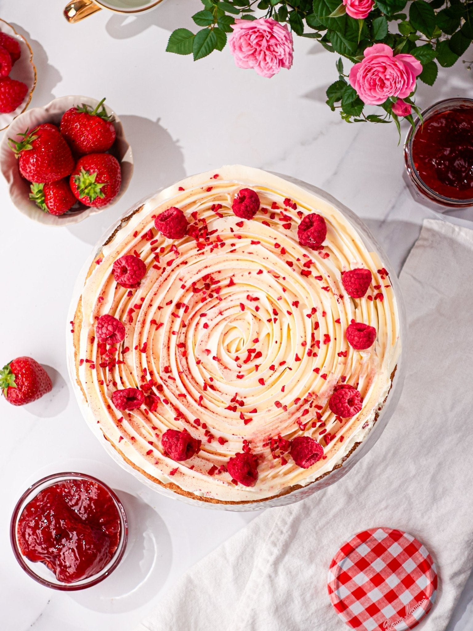Patisserie Valerie's handmade 60th Birthday Cake Bundle - Victoria Sponge cake being decorated and sliced