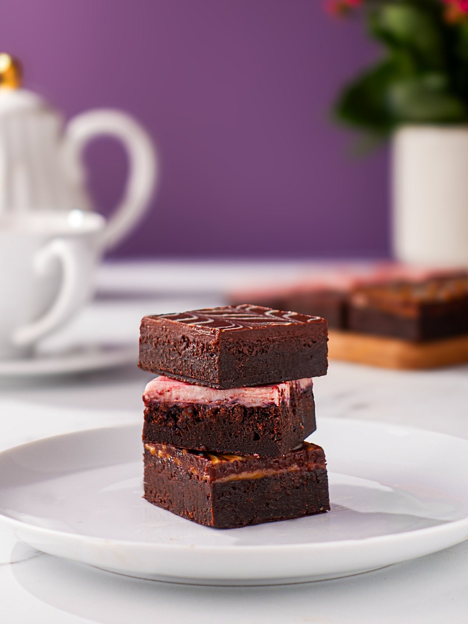 Patisserie Valerie's handmade Chocolate Fudge Brownies being baked and iced with feathered chocolate fudge topping