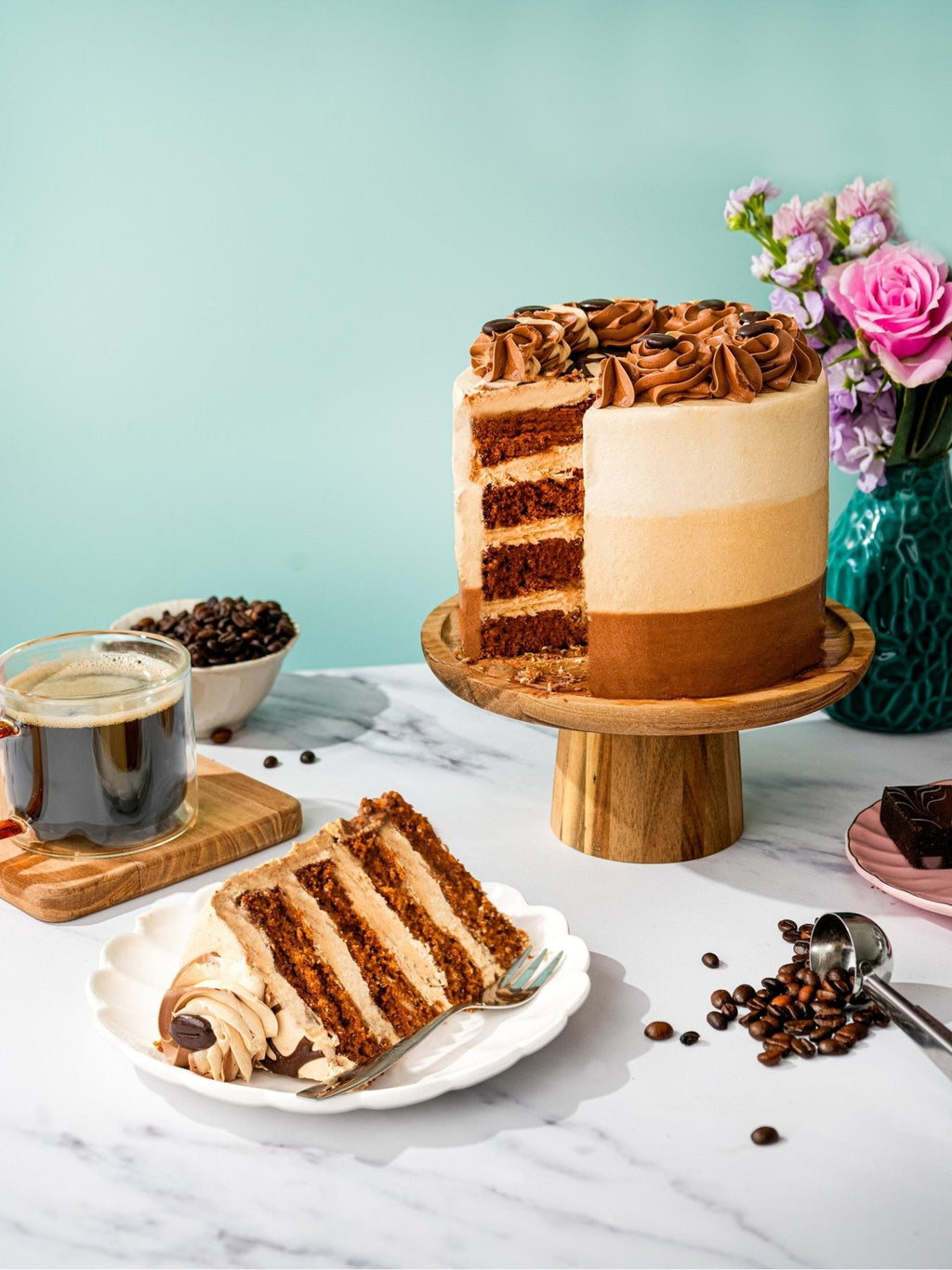 Patisserie Valerie's handmade Coffee Cake, decorated with chocolate rosettes, being sliced and served