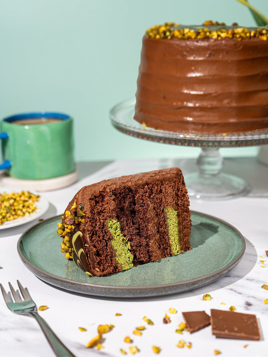 Patisserie Valerie's handmade Dubai-Style Favourites Trio Bundle - the pistachio chocolate cake sliced and served