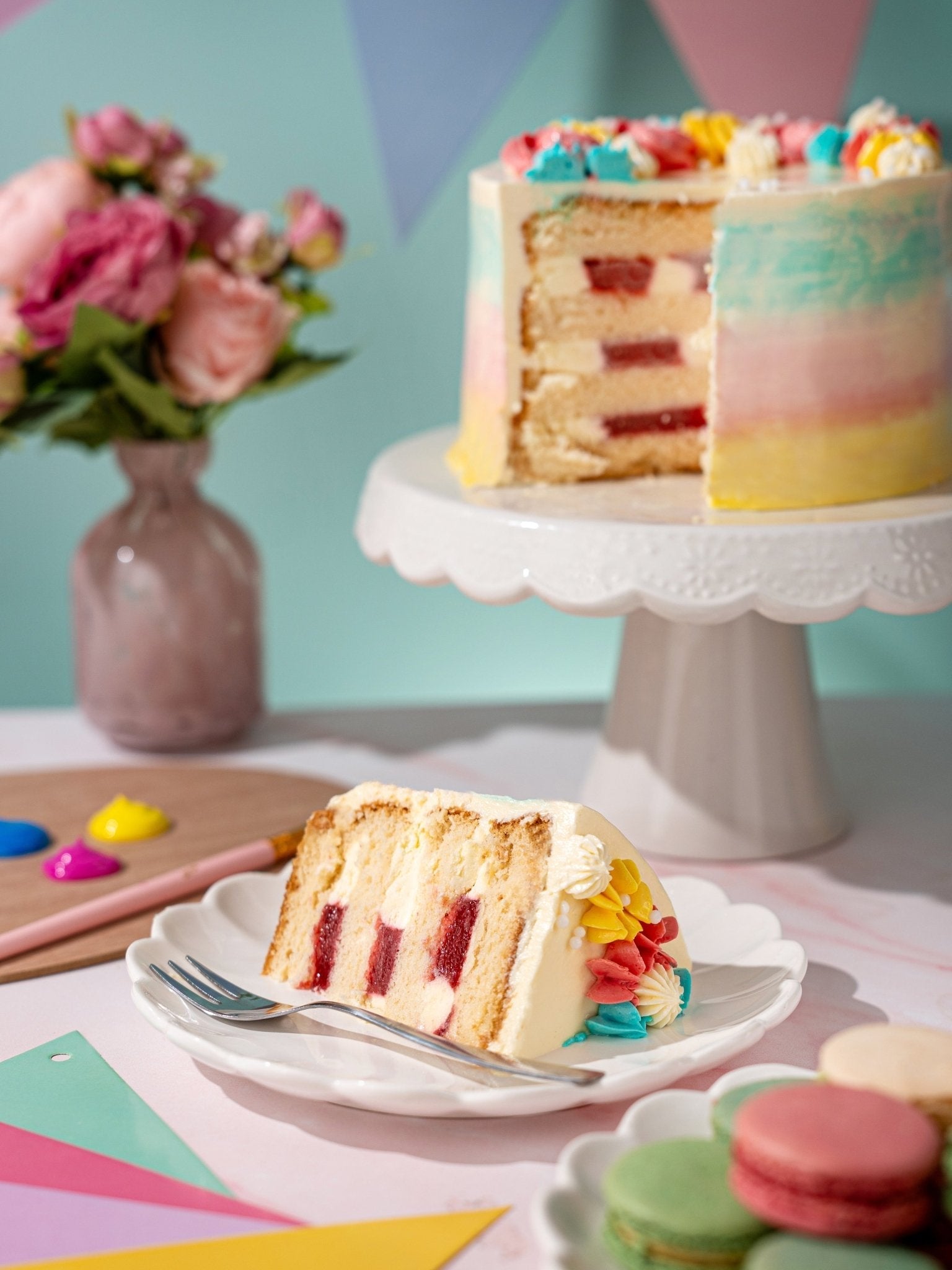 Patisserie Valerie's handmade Pastel Dream Celebration Cake being sliced and served