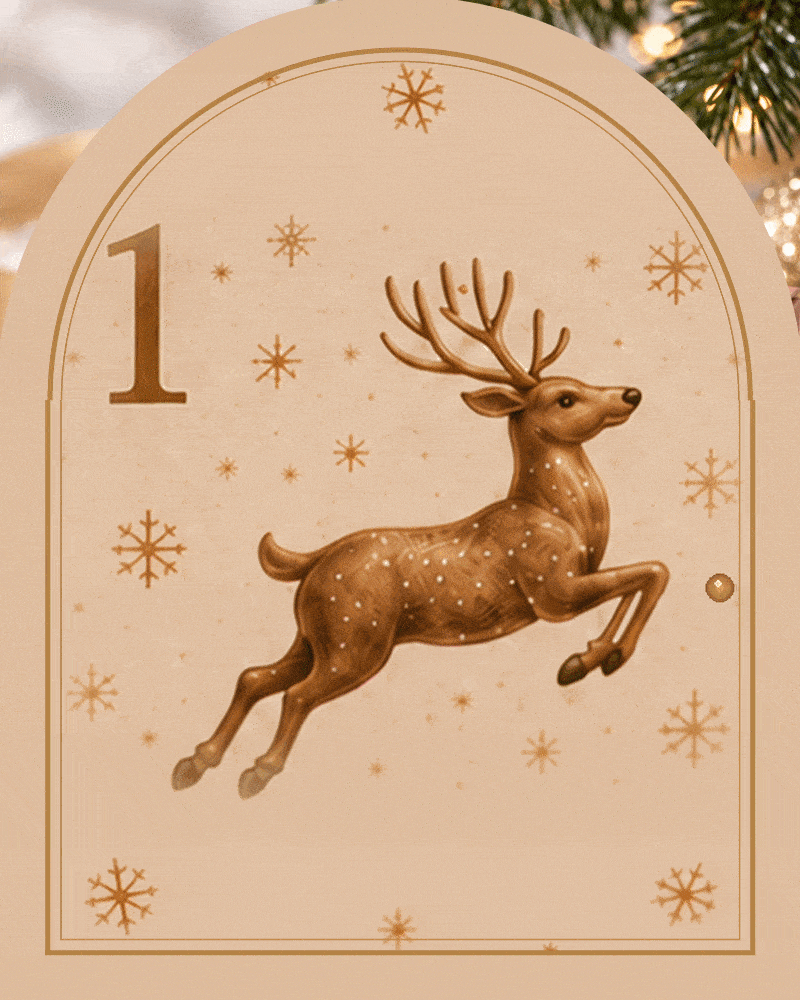 Arched door 1 of the Patisserie Valerie advent calendar opening in a shimmer of gold sparkles to reveal boxes 1 and 13 with a white chocolate star and a gold sprinkled brownie Christmas tree