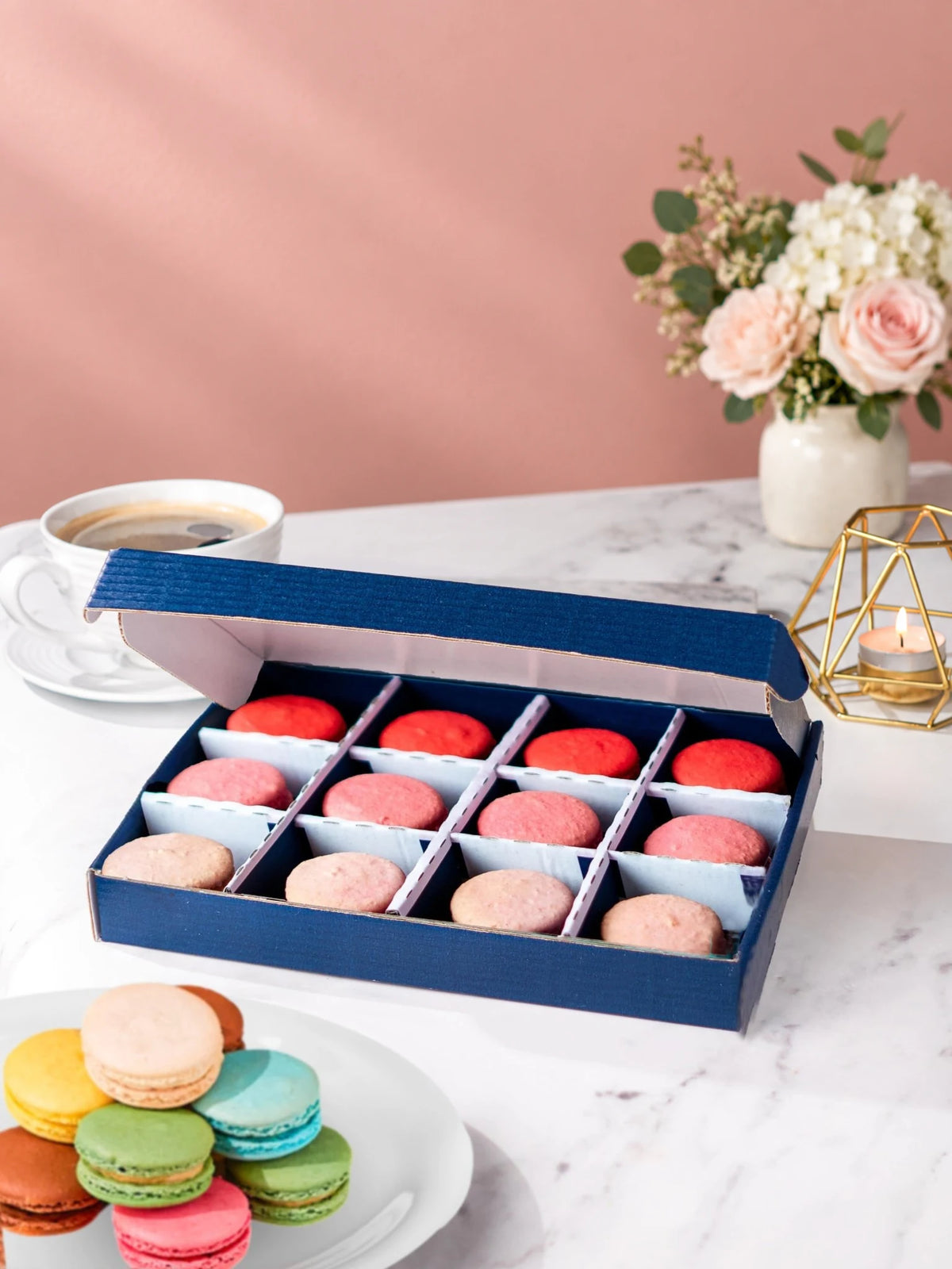 Open gift box of 12 strawberry, raspberry & rose macarons by Patisserie Valerie